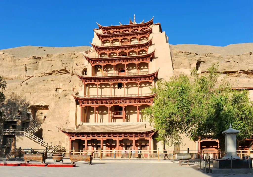 Front view of the Mogao Caves, also referred to as the Thousand Buddha Caves (Photo: Britannica).